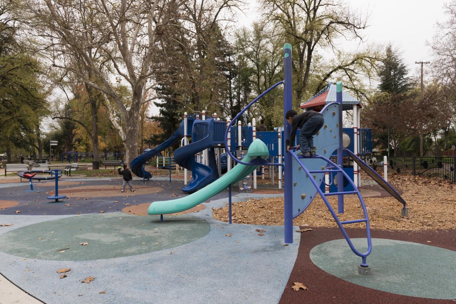 Children playing on playground equipment at Riverside Commons